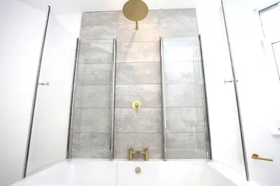 a shower with a glass door in a bathroom at Three Bedroom Upper Flat in Jordanhill in Glasgow