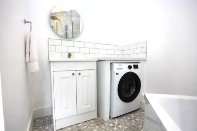 a washing machine in a bathroom with a mirror at Three Bedroom Upper Flat in Jordanhill in Glasgow