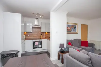 a living room with a couch and a table at 3 Bedroom Duplex with Free Parking in Glasgow