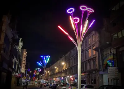 a street at night with colorful street lights at The Art Flat Woodlands in Glasgow