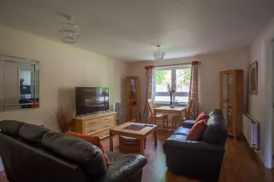 a living room with two couches and a television at Homely Flat close to Centre with Free Parking in Glasgow