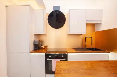 a kitchen with white cabinets and a sink at Stunning Flat in West End Location in Glasgow