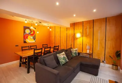 a living room with a couch and a table at Beautiful 2 Bed Flat with a Private Terrace in Glasgow