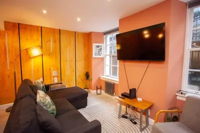 a living room with a couch and a flat screen tv at Beautiful 2 Bed Flat with a Private Terrace in Glasgow