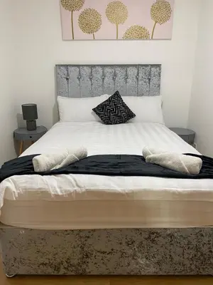 a large bed with white sheets and pillows on it at Pure East Coast Trainline by TBA in Fife