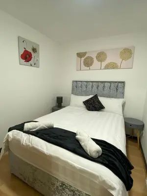 a bedroom with a large white bed with two tables at Pure East Coast Trainline by TBA in Fife
