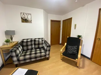 a living room with a couch and a chair at Pure East Coast Trainline by TBA in Fife
