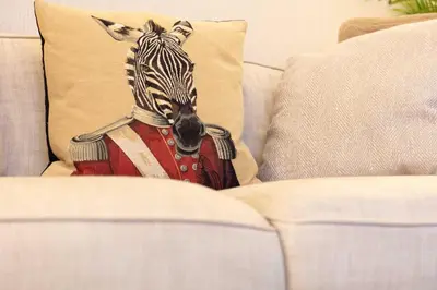 a zebra pillow sitting on top of a couch at The Bradshaw in Prestwick