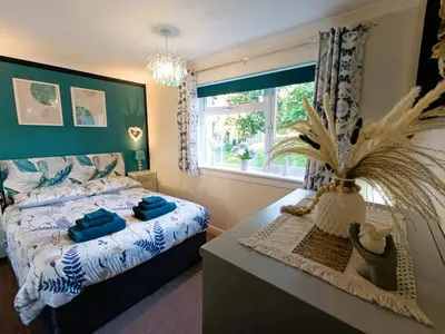 a bedroom with a bed and a large window at Double Room in Riverside Apartment - C in Glasgow