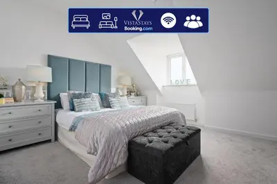 a bedroom with a large bed and a blue sign at 3BDR House By Vista Stays Short Lets & Serviced Accommodation Glasgow Scotland With Driveway Parking and PS4 in Glasgow