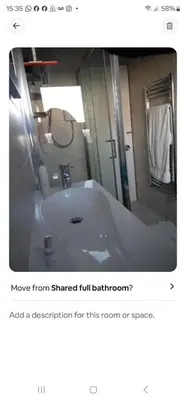 a bathroom with a white tub and a mirror at Garden homely house in Cardonald