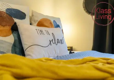 a bed with a pillow that says time to return at Drumpellier Apartment by Klass Living Coatbridge in Coatbridge
