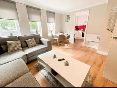 a living room with a couch and a table at Central two bedroom, Free private parking in Glasgow