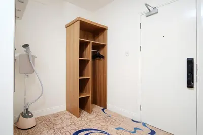 a room with a book shelf next to a door at Kelpies Hotel Falkirk in Falkirk