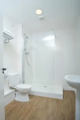 a bathroom with a shower and a toilet and a sink at Kelpies Hotel Falkirk in Falkirk