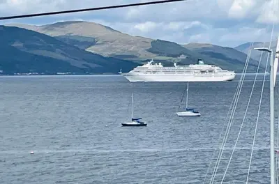 a large cruise ship in the water with boats at THE RESTING LION - Gourock Town Center Holiday Home Apartment in Gourock