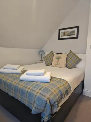a bedroom with two beds with towels on them at Beolary in Oban