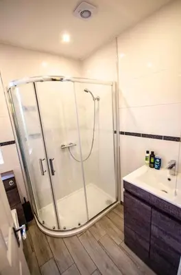 a bathroom with a shower and a sink at Spacious 4-Bedroom House in Glenboig in Glenboig