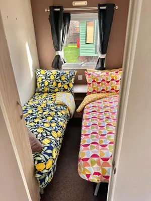 two beds and pillows in a small room at Delta, Bromley 4-Bedroom Located in Uddingston, Glasgow at Maryville Caravan Site in Uddingston