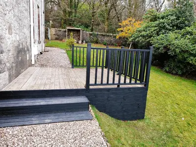 a black fence sitting next to a walkway at Bella Vista Manor - with elevated views over Rothesay & Loch Striven in Rothesay