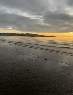a beach with a cloudy sky and the ocean at No 10, Ayr, 130m2, New Decor December 2024, All new entire 3 bedroom garden house in Ayr