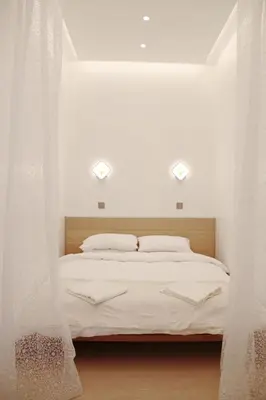a bedroom with a white bed with curtains around it at Edinburgh city centre 1Bed flat near Castle & Uni in Edinburgh