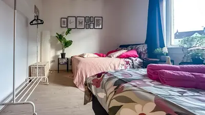 a bedroom with two beds and a window at Holly street house with Separate Entrance,Glasgow edge in Clydebank