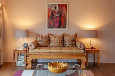 a living room with a couch and a painting at Invercreran House in Appin