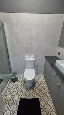 a bathroom with a toilet and a sink at Bellshill Central Apartment in Bellshill