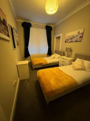 a bedroom with two beds and a window in it at Peaceful Place in Falkirk