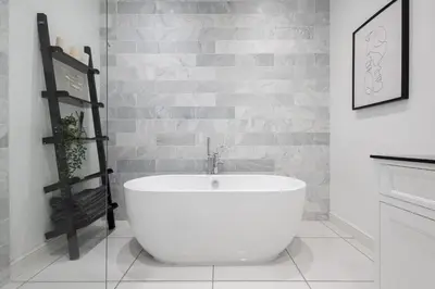 a bathroom with a large white tub in a room at Extravagant 6 Bed Victorian Townhouse with Hot Tub in Glasgow