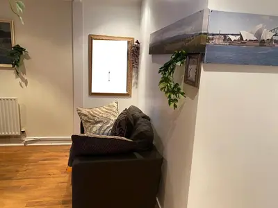 a living room with a couch and a window at Harbury Lodge in Scotstoun West Station