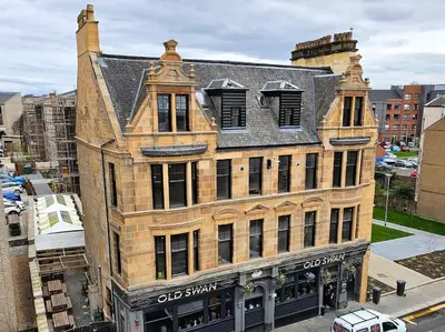 an old brick building on a city street at 1 Smithhills Sleeps 5 Central and Spacious in Paisley