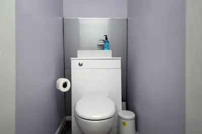 a bathroom with a white toilet and a sink at Modern City Centre Apartment in Central Hub in Edinburgh