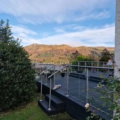 a balcony with a view of a river and mountains at Sachsblick in Lochgoilhead