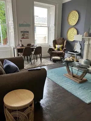 a living room with a couch and chairs and a table at Apartment 28 in Ayr