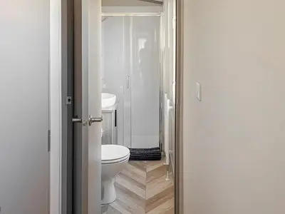 a white bathroom with a toilet and a sink at Katie's Cosy Caravan - Uk48380 in Ardgour