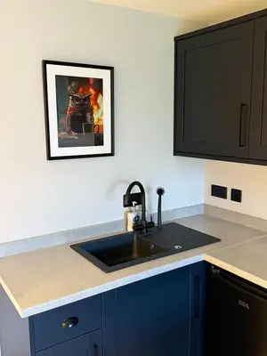a kitchen with a sink and a picture on the wall at River Logie Lodges in Westfield