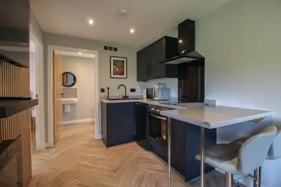 a kitchen with blue cabinets and a counter top at River Logie Lodges in Westfield