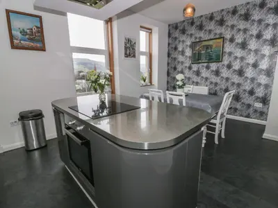a kitchen and dining room with a table and chairs at Ailsa View in Girvan