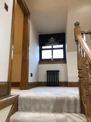 an attic room with a staircase and a window at 2-Bed Cottage Sleeps 4 10 mins to Glasgow Centre in Glasgow