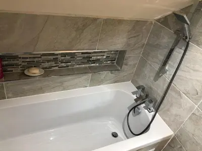 a white bath tub in a bathroom with a shower at 2-Bed Cottage Sleeps 4 10 mins to Glasgow Centre in Glasgow