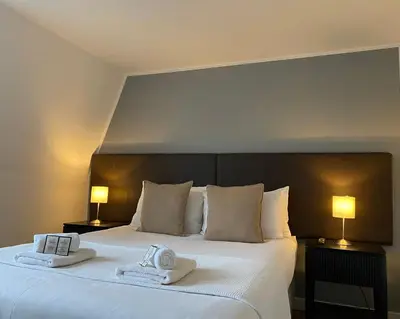 a bedroom with a large bed with towels on it at CS Exclusive Apartments of Princess Street West End in Edinburgh