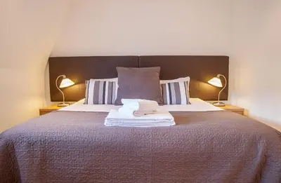 a bedroom with a large bed with two lamps at CS Exclusive Apartments of Princess Street West End in Edinburgh