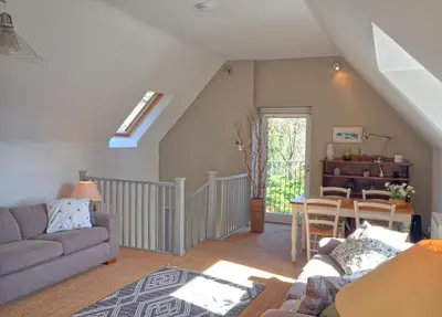 a living room with a couch and a table at Black Barony Home Farm Cottage in Eddleston