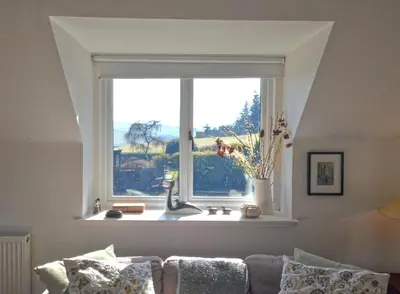 a window with a sink in a living room at Black Barony Home Farm Cottage in Eddleston