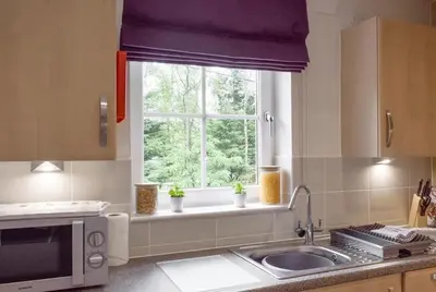 a kitchen with a sink and a window at Am Tighndhuin in Killin