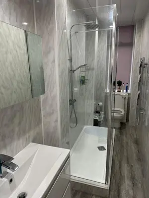 a bathroom with a shower and a sink and a toilet at Cosy Flat in Glasgow