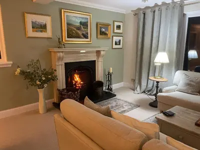 a living room with a fireplace and a couch at Castlecroft Bed and Breakfast in Stirling