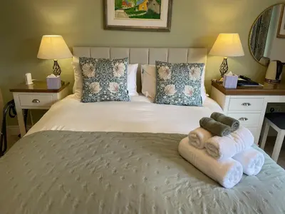 a bedroom with a bed with towels on it at Castlecroft Bed and Breakfast in Stirling